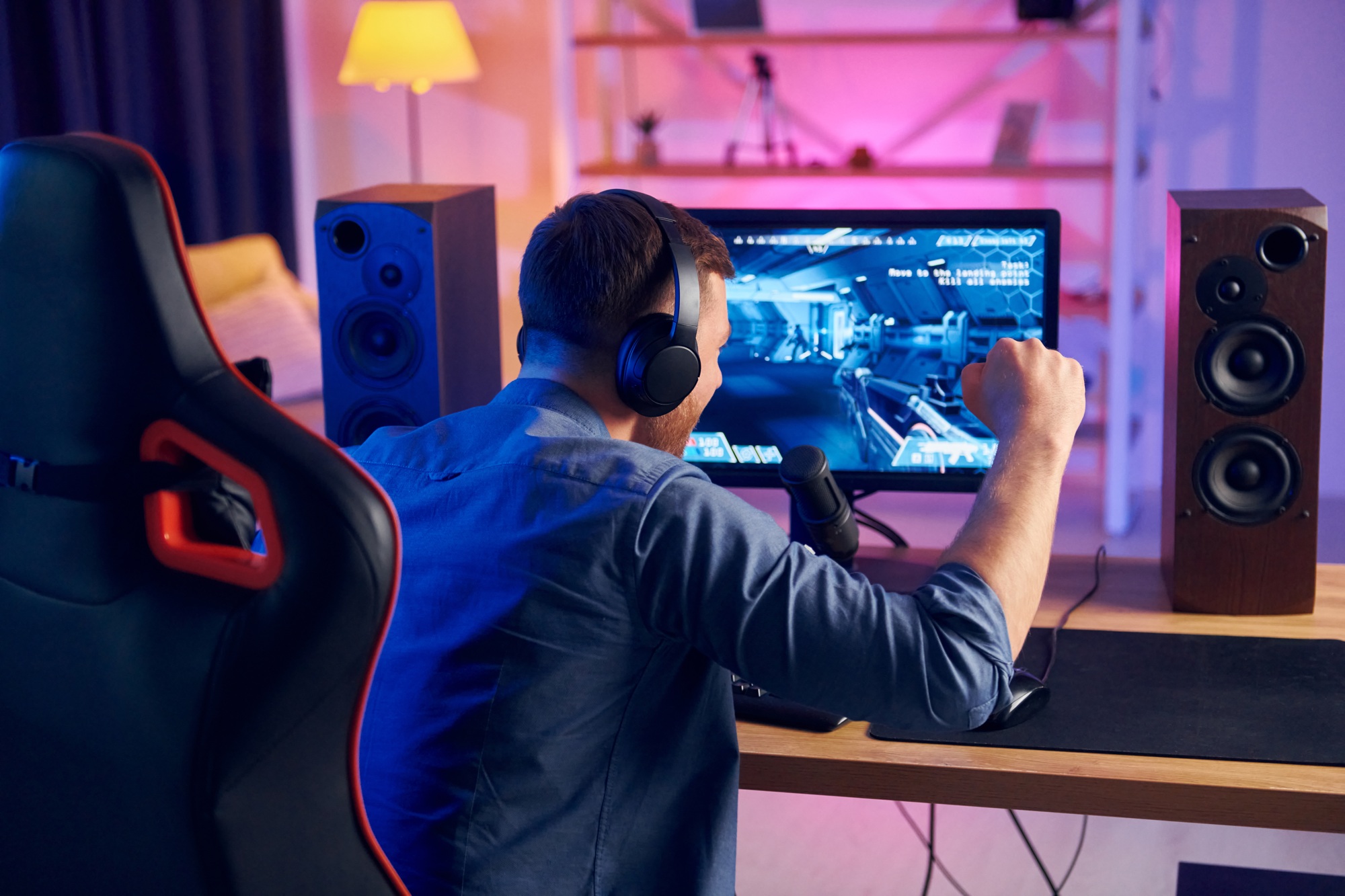 Nice gaming chair. Online streamer playing FPS shooter at home