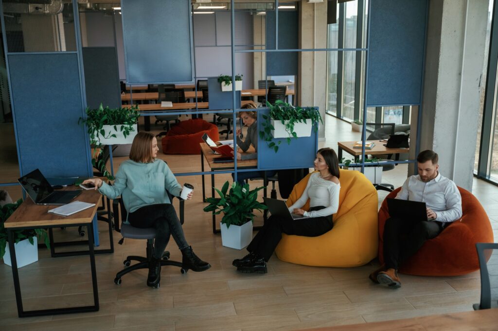 People are working in the office with bean bags chairs in it