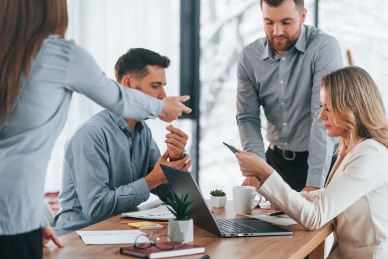 Using brainstorming technique. Group of business people that working on the project in the office
