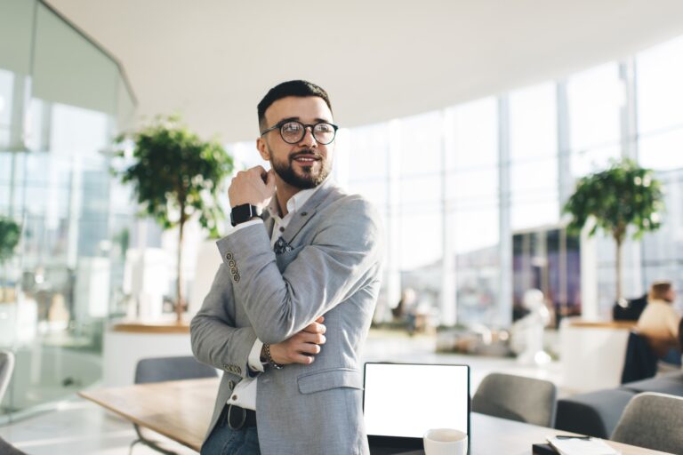 Smiling businessman in shirt and jacket in modern office