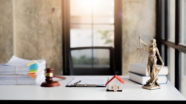 Law office with Judge's hammer book, scales of justice and laptop on lawyer's desk