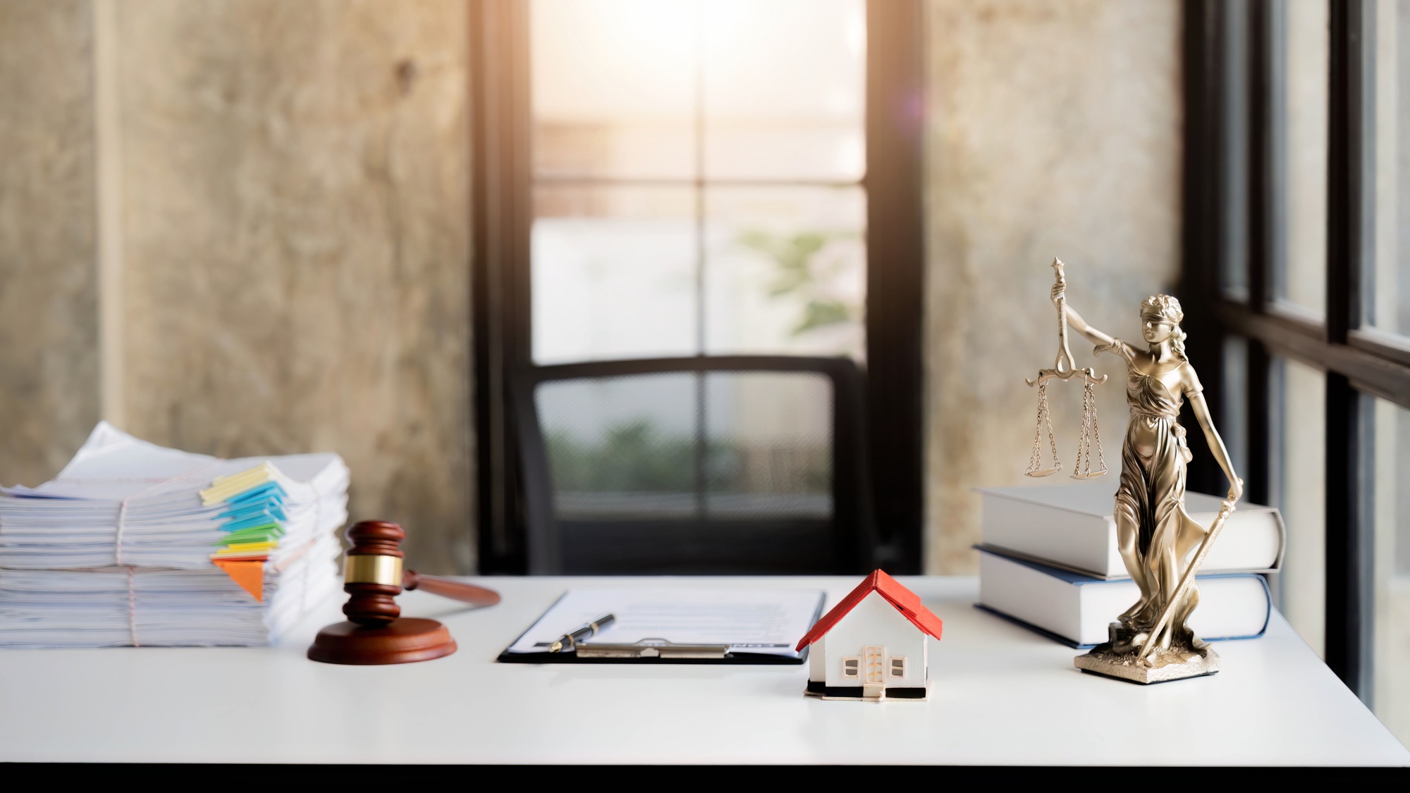 Law office with Judge's hammer book, scales of justice and laptop on lawyer's desk